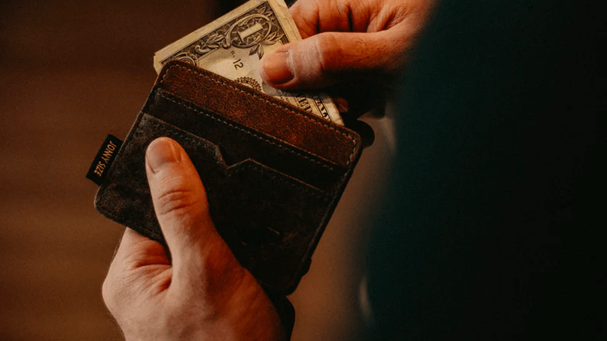 A man pulling money out of his wallet.
