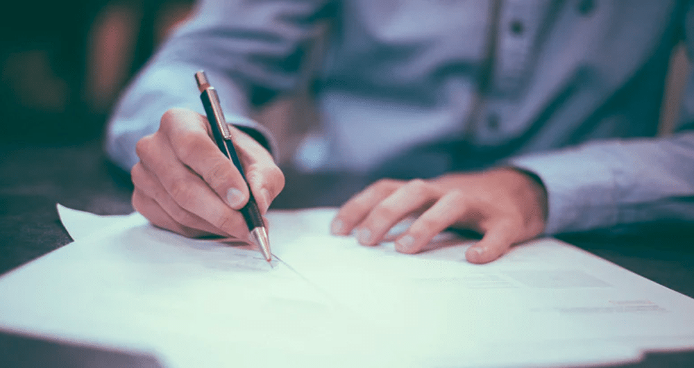 estate planning - person signing legal documents