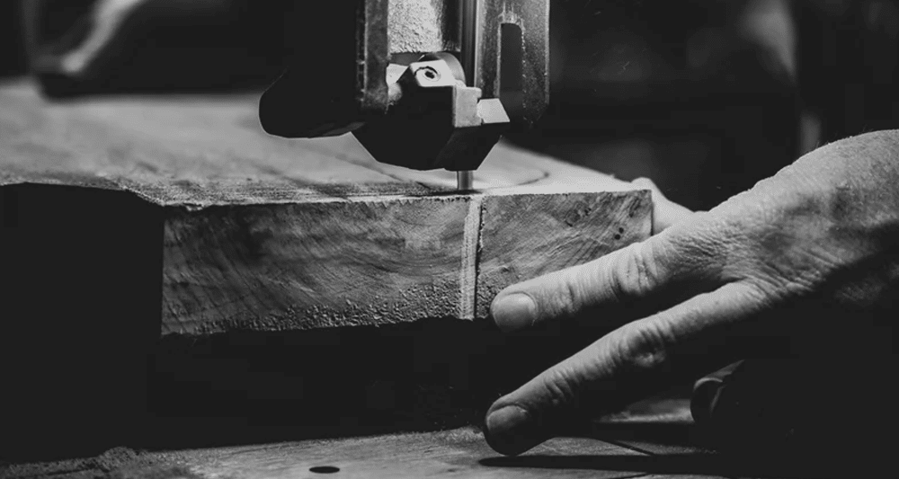 Person cutting wood with a bandsaw