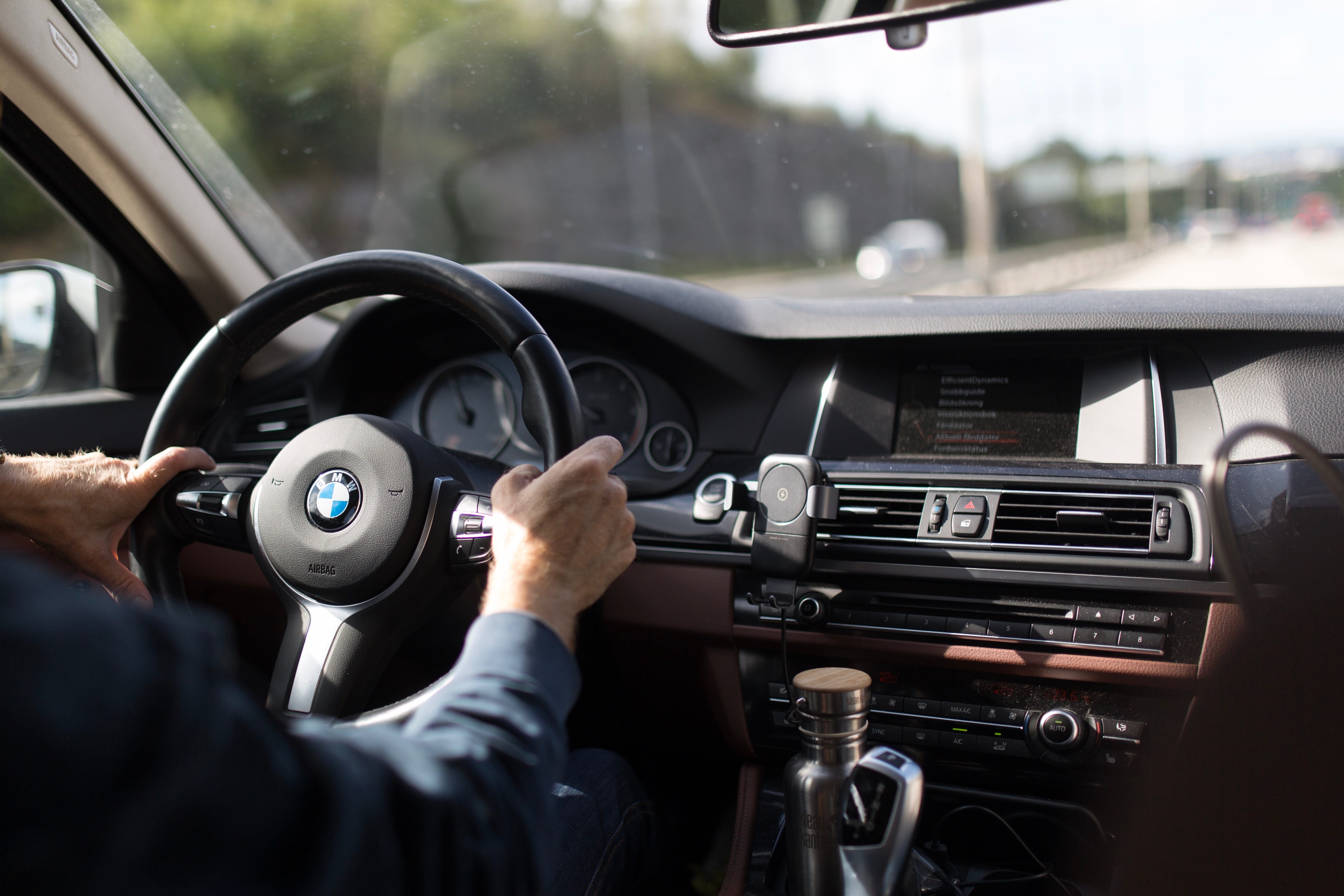 person behind the wheel of a car