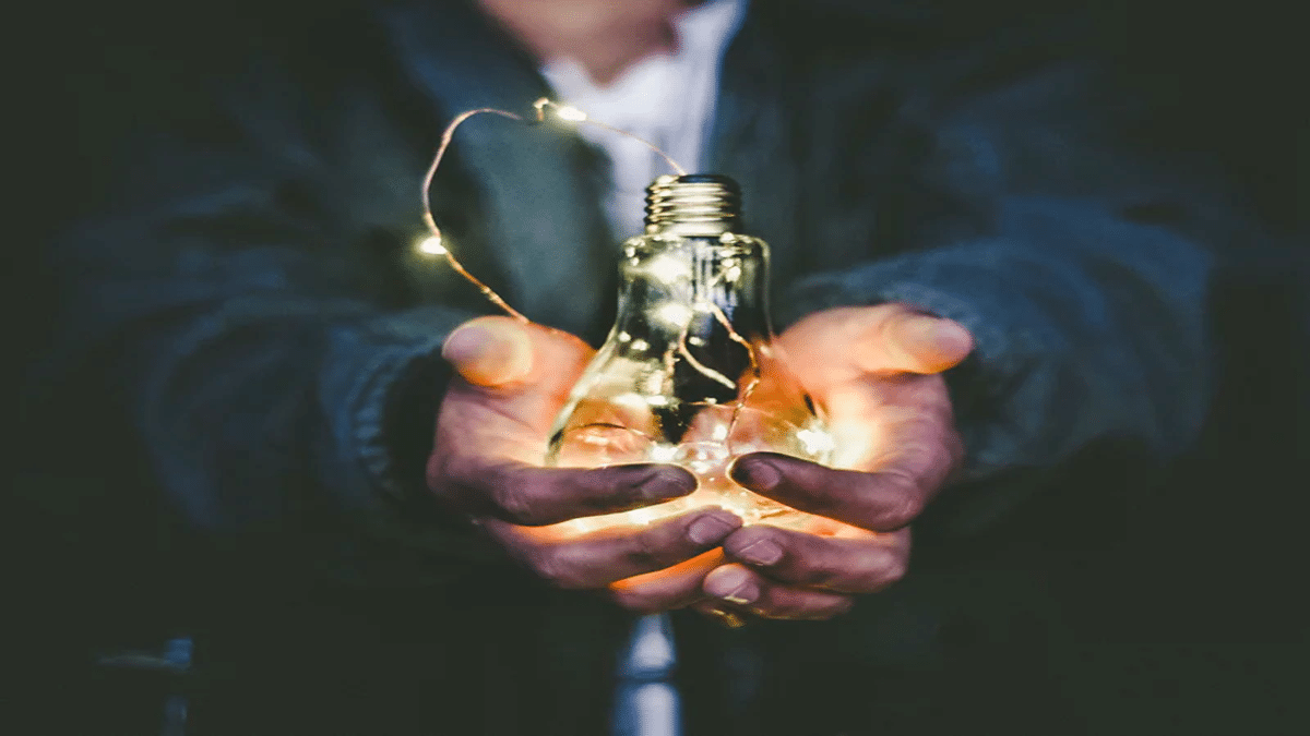 hands holding lightbulb