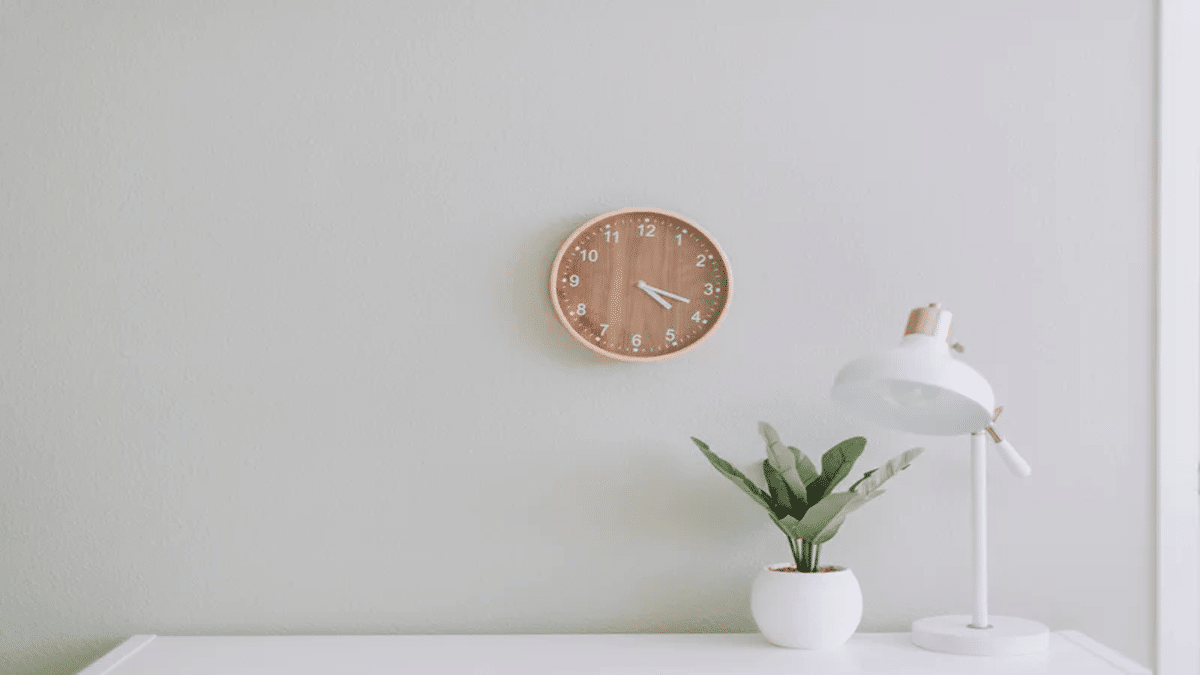 desk with wall clock and plant