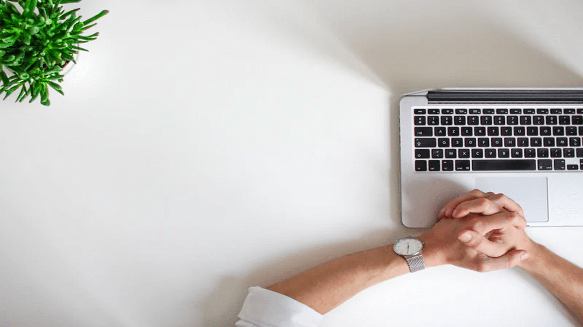 hands on laptop at desk